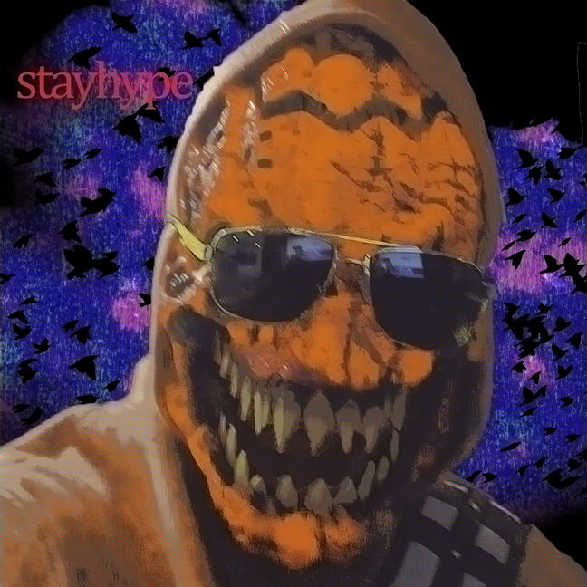 a person in a hoodie and sunglasses wearing an orange mask